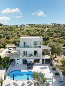 an aerial view of a villa with a swimming pool at Stork Apartments in Hanioti