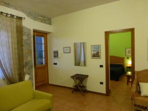a living room with a green couch and a door at Casa Di Lascio in Maratea