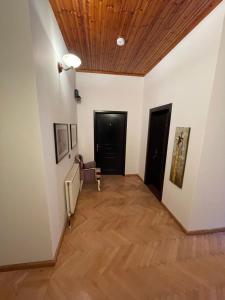 a hallway with white walls and a wooden ceiling at Vila AT in Berat