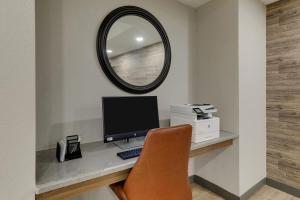 a desk with a computer and a mirror at Candlewood Suites Lexington, an IHG Hotel in Lexington