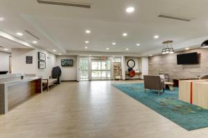 an office lobby with a reception desk and a tv at Candlewood Suites Lexington by IHG in Lexington