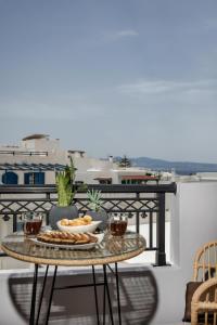 a table with food and drinks on a balcony at Lago m Superior Naxos Town in Naxos Chora +26 photos