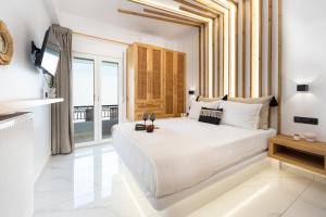 a bedroom with a large bed and a large window at Lago m Superior Naxos Town in Naxos Chora