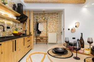 a kitchen with wooden cabinets and a table at Lago m Superior Naxos Town in Naxos Chora