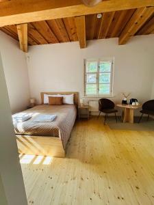 a bedroom with a bed and a wooden floor at In heart of Trakai you'll find authentic Karaim house in Trakai