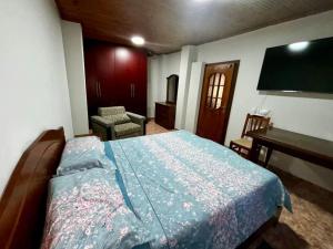 a bedroom with a bed and a desk and a television at Central 2 Floor, Duplex in Elbasan +3 photos