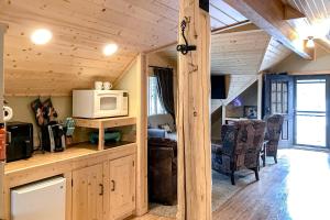 a kitchen and living room in a log cabin at Poppy's Place Studio in South Fork +3 photos