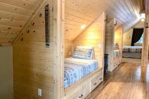 a bedroom with a bed in a log cabin at Poppy's Place Studio in South Fork
