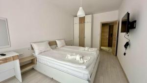 a bedroom with a bed with a dog laying on it at Green Paradise Complex in Primorsko