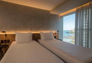 Postel nebo postele na pokoji v ubytování Hotel Luzeiros Fortaleza
