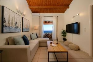 a living room with a couch and a table at Corfu Glyfada Beach Apartment in Glyfada