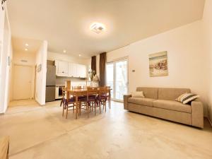 a living room with a couch and a table at L'attico di Dimore del Sud in Trani