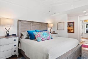 a bedroom with a bed and a dresser with a pillow at It is a Happy Day at the Beach in Pawleys Island