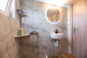 a bathroom with a sink and a shower at Demi's Apartments Near Athen's Airport in Artemida