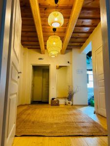 an empty hallway with a wooden ceiling and a chandelier at In heart of Trakai you'll find authentic Karaim house in Trakai