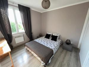 a bedroom with a bed with two pillows on it at Le Belvédère + Clim + Extérieur + Parking Gratuit in Les Angles Gard