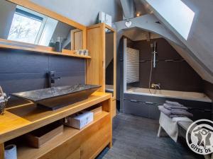 a bathroom with a sink and a bath tub at Gîte charmant avec jardin, proche activités nautiques - FR-1-622-75 in Morannes +19 photos