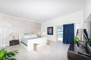 a white bedroom with a bed and a television at Shaomi South Beach in Miami Beach +135 photos