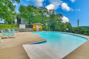 a swimming pool in a yard with a house at Hike and Leaf Peep! Condo 2 Mi to Silver Dollar City in Branson West