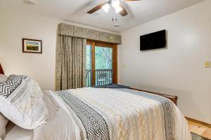 a bedroom with a bed and a window at Hike and Leaf Peep! Condo 2 Mi to Silver Dollar City in Branson West +30 photos