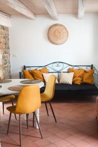 a living room with a couch and a table and chairs at Casa Antica Pietra Spilimbergo in Spilimbergo
