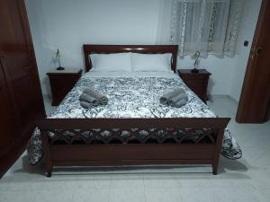a bedroom with a bed with two shoes on it at La Foggia seaside paradise in Siculiana