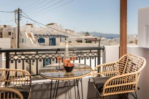 a table and chairs on a balcony with a view at Lago m Superior Naxos Town in Naxos Chora
