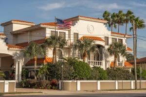 a white house with palm trees in front of it at Hampton Inn St Augustine US1 North in St. Augustine