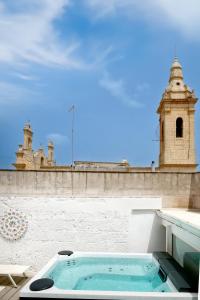 a hot tub on the roof of a building at Il Nido Luxury Apartment in Montesano Salentino