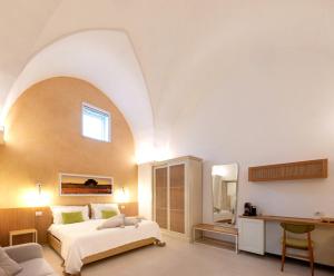 a bedroom with a large bed with an arched ceiling at Il Nido Luxury Apartment in Montesano Salentino +27 photos