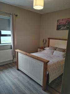 a bedroom with a large bed and a window at Parkhill House Self Catering in Ballyshannon