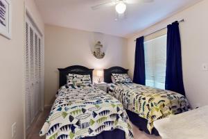 two beds sitting next to each other in a bedroom at Spa on Port Royal Sound 1123 in Hilton Head Island +42 photos