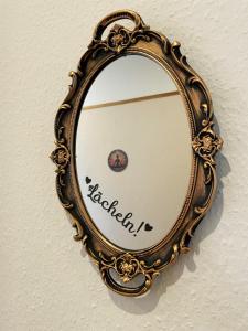an ornate mirror hanging on a wall at Wohlfühloase in der City in Luckenwalde +11 photos