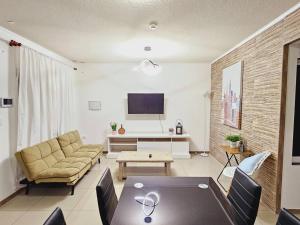 a living room with a couch and a table at Apartamentos y Habitaciones Privadas in Antofagasta
