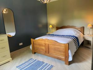 a bedroom with a bed and a dresser and a mirror at Les charmes de l'Yères in Criel-sur-Mer