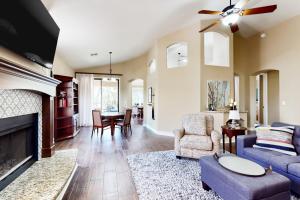 a living room with a couch and a fireplace at Cardinal Comfort in Litchfield Park