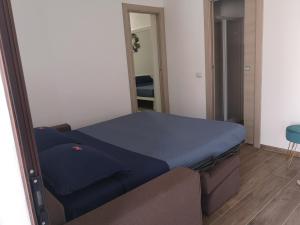a large bed in a room with a mirror at Villa Azzurra in Lampedusa
