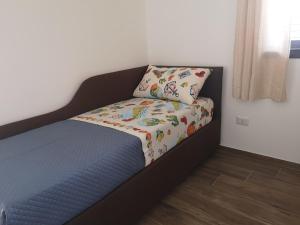 a bedroom with a bed with a pillow on it at Villa Azzurra in Lampedusa