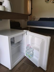 an open refrigerator with bottles of water in it at Villa Azzurra in Lampedusa