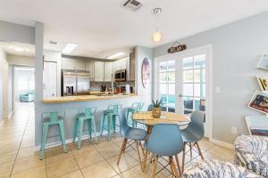 a kitchen and dining room with a table and chairs at Water-view dog-friendly home with outdoor space & entertainment options in Palm Coast