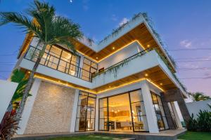 a house with a palm tree in front of it at The Kaba Kaba Private Luxury Villa in Tumbak Bayuh