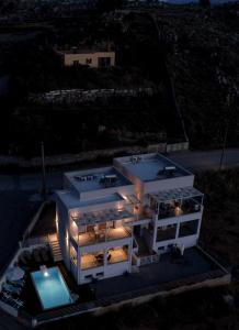 an aerial view of a house at night at Sun Angelo luxury apartment in Paradise 2 in Arménoi