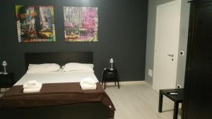 a bedroom with a bed with two towels on it at B&B Colors in Sellia Marina