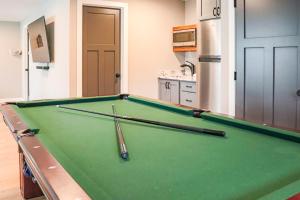 a pool table in a kitchen with three bats on it at Lost Lake Lodge in Nisswa