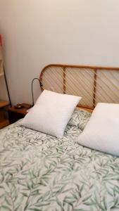 Una cama con dos almohadas encima. en Acogedor y luminoso apartamento en Neguri, en Getxo