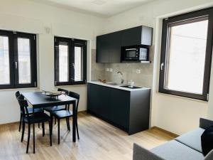 a kitchen and dining room with a table and chairs at Antico Borgo sul Mare in Petacciato