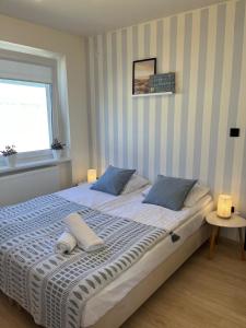 Posteľ alebo postele v izbe v ubytovaní Karwia Pokoje & Apartamenty
