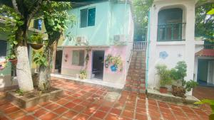 ein Haus mit einem gemauerten Bürgersteig davor in der Unterkunft House Marfito Airport in Cartagena de Indias