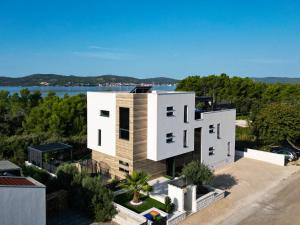 an aerial view of a house with a lake at Apartmani Vito in Biograd na Moru