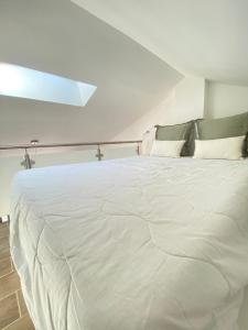 a large white bed in a white room at Coastal Dream in Finale +13 photos